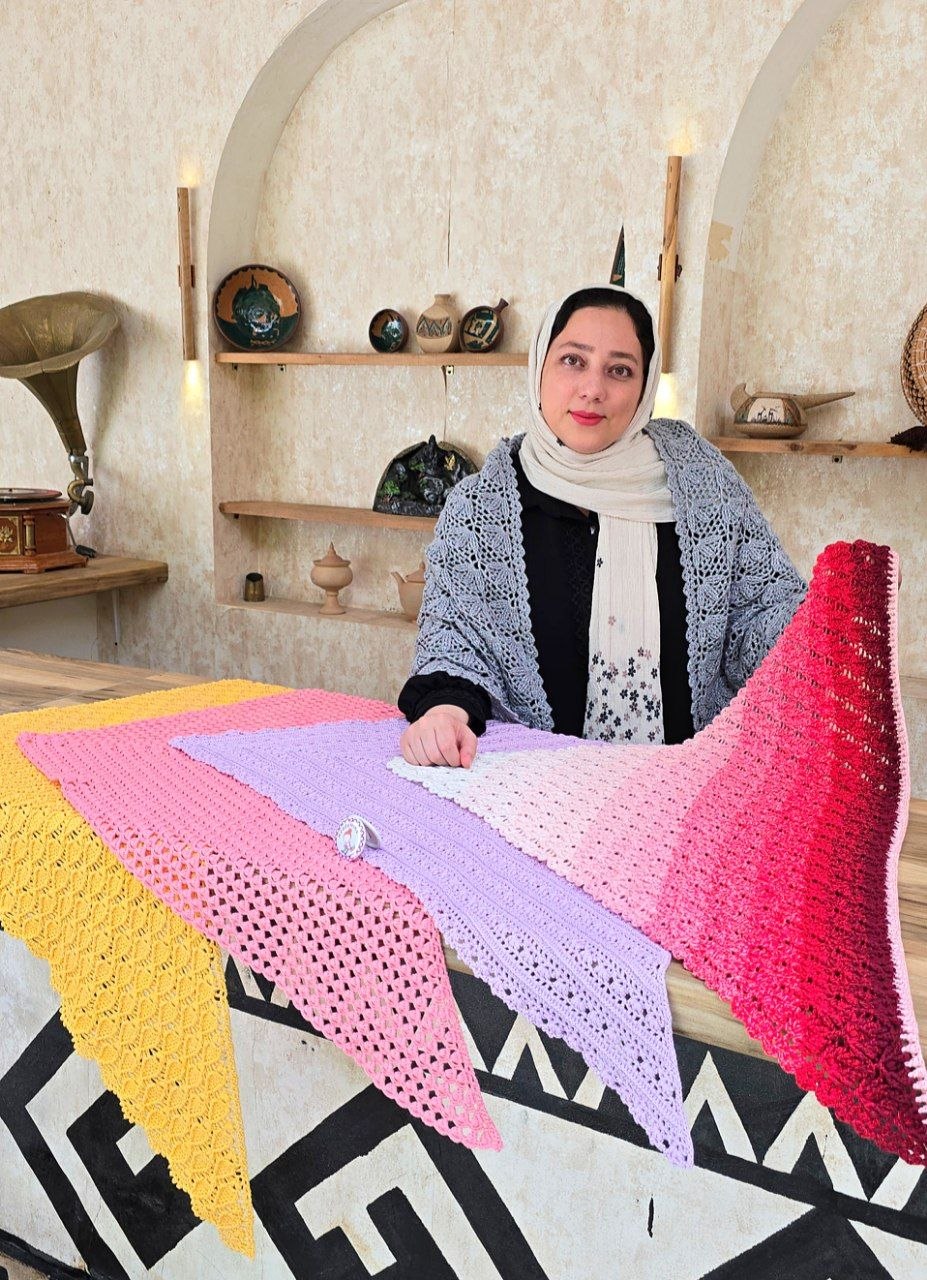 مینا محمدیان در کنار اشارپ های دستباف پکیج آغوش آکادمینا